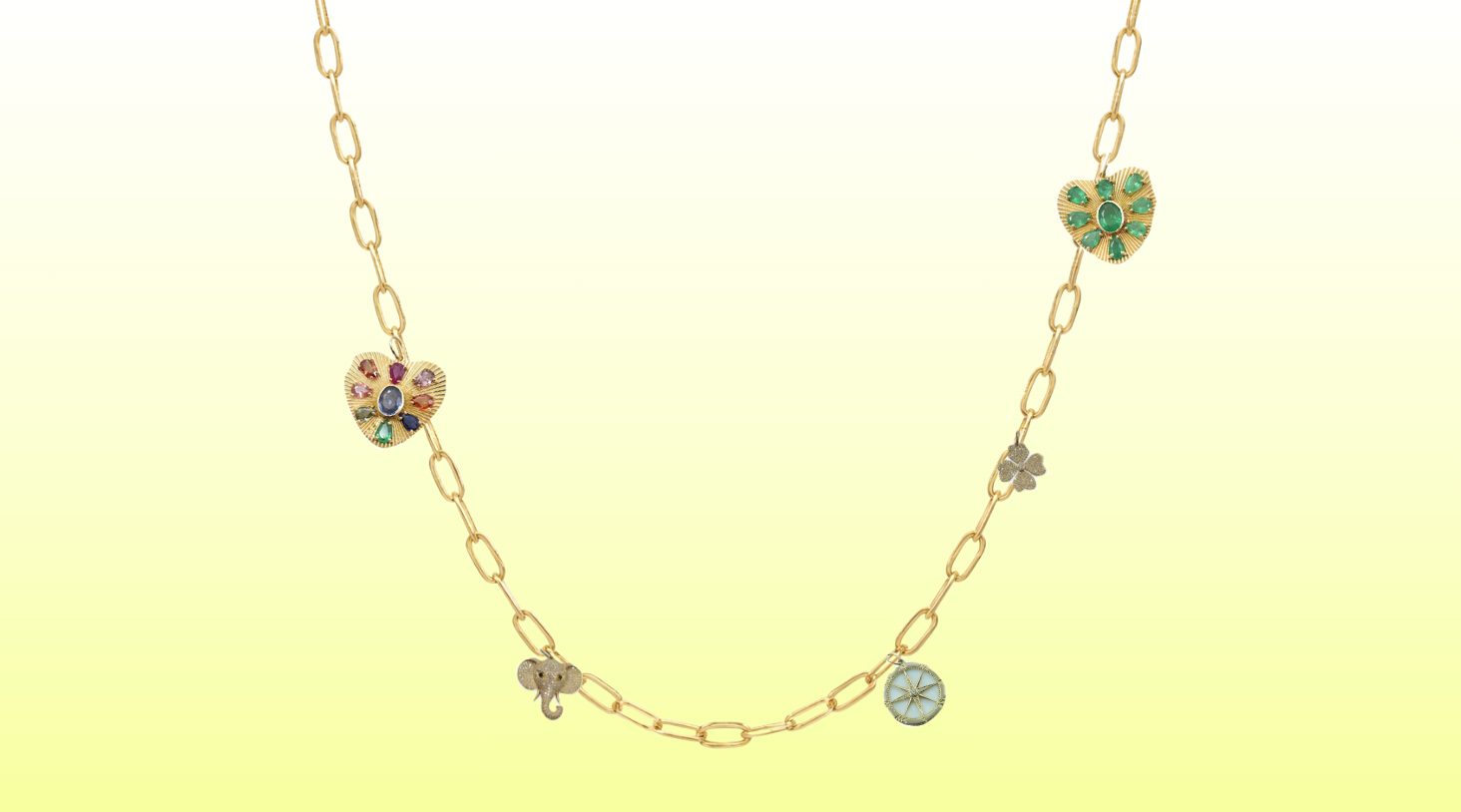 Gold necklace with heart-shaped pendants on a gradient yellow background
